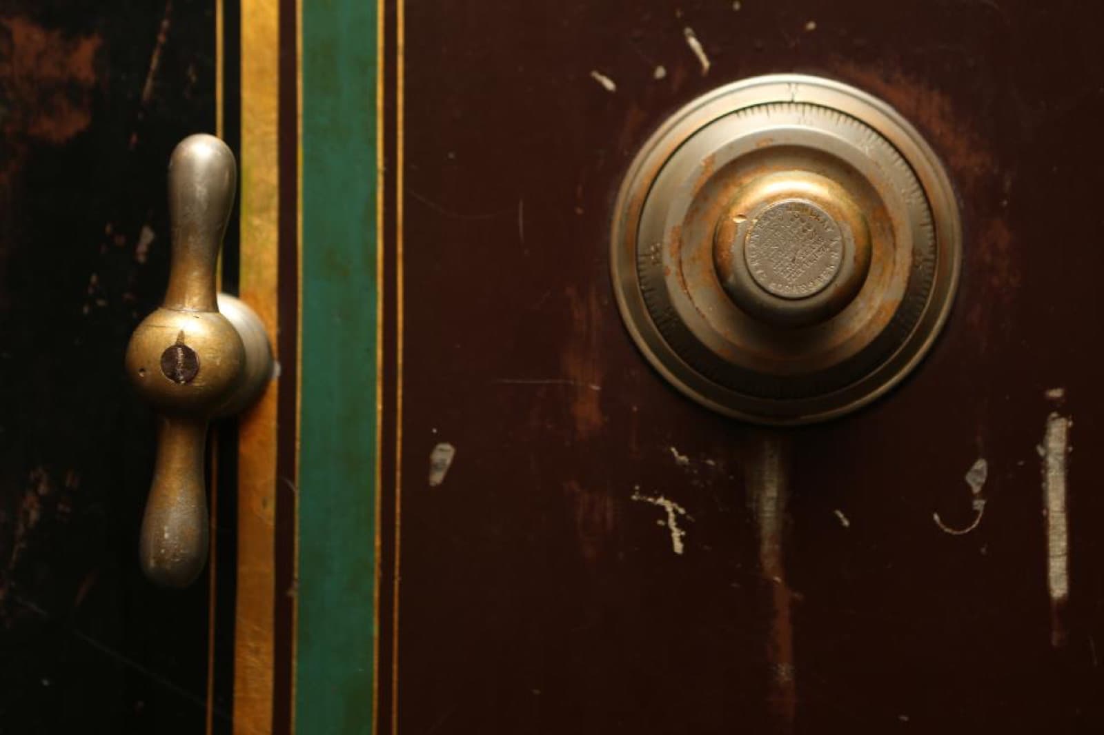 A vintage combination dial on a bank vault door