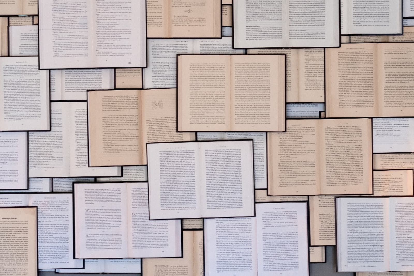A layered collage of open book pages